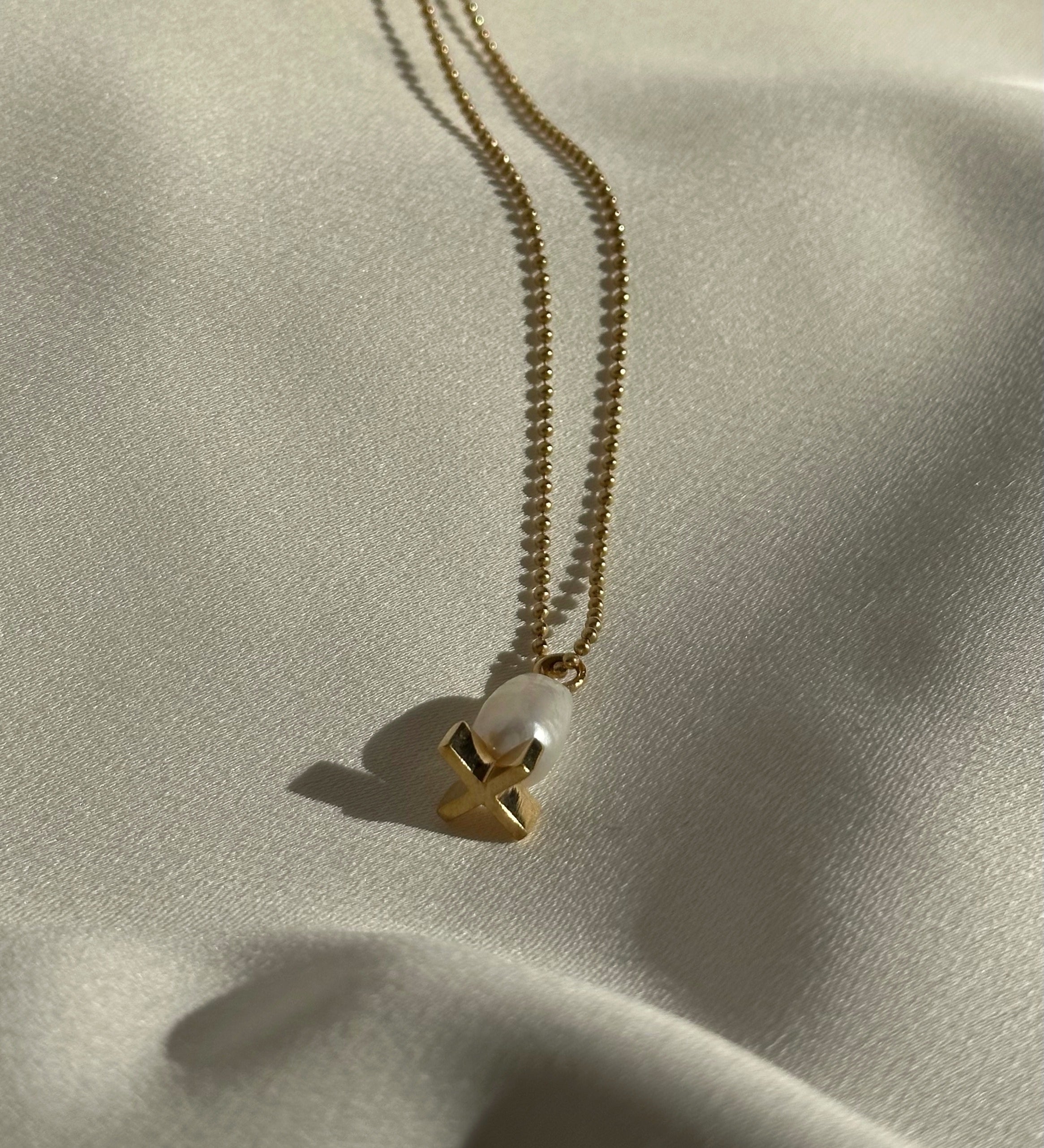 X pearl pendant
